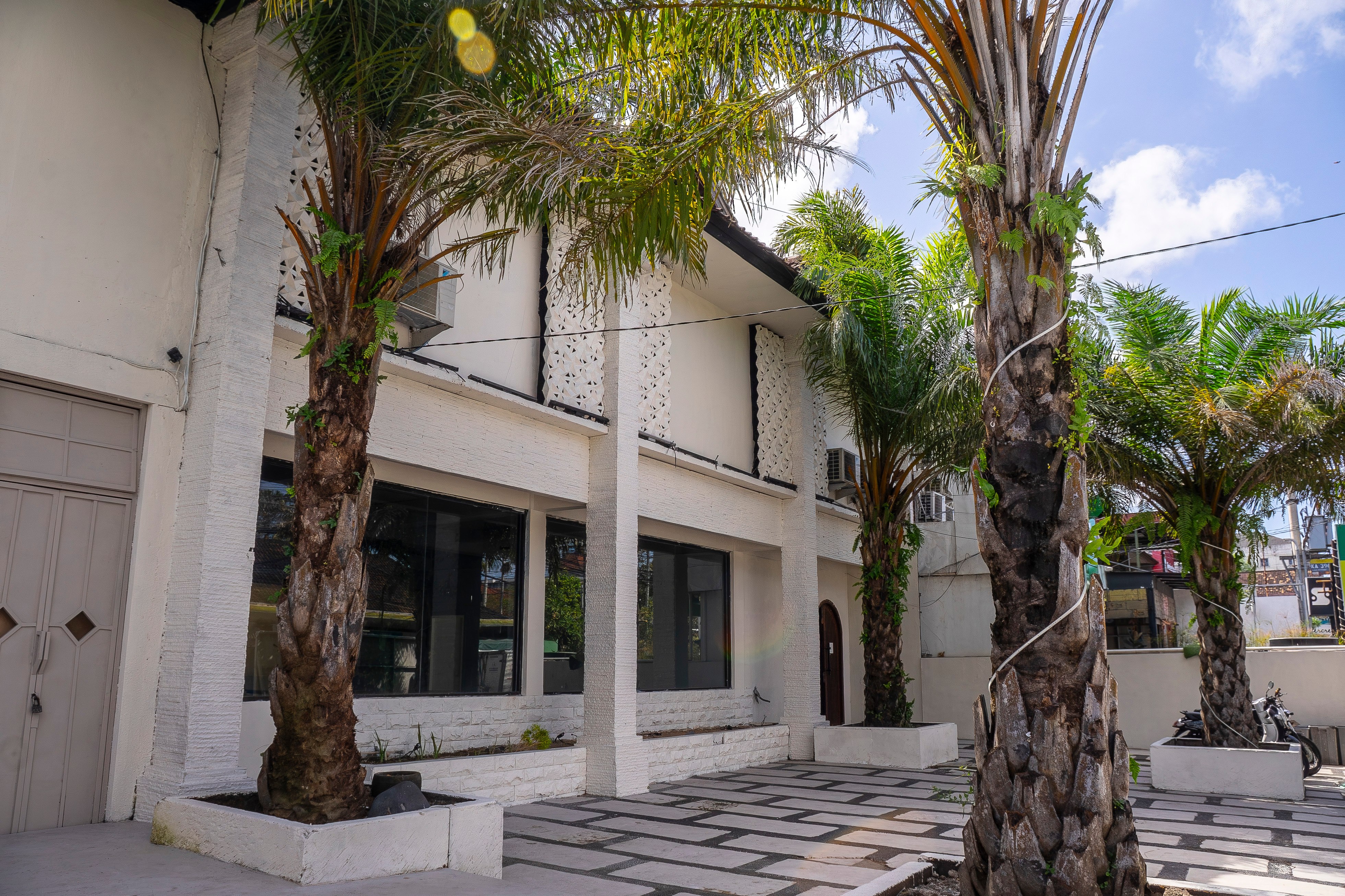 Exterior building facade with palm trees