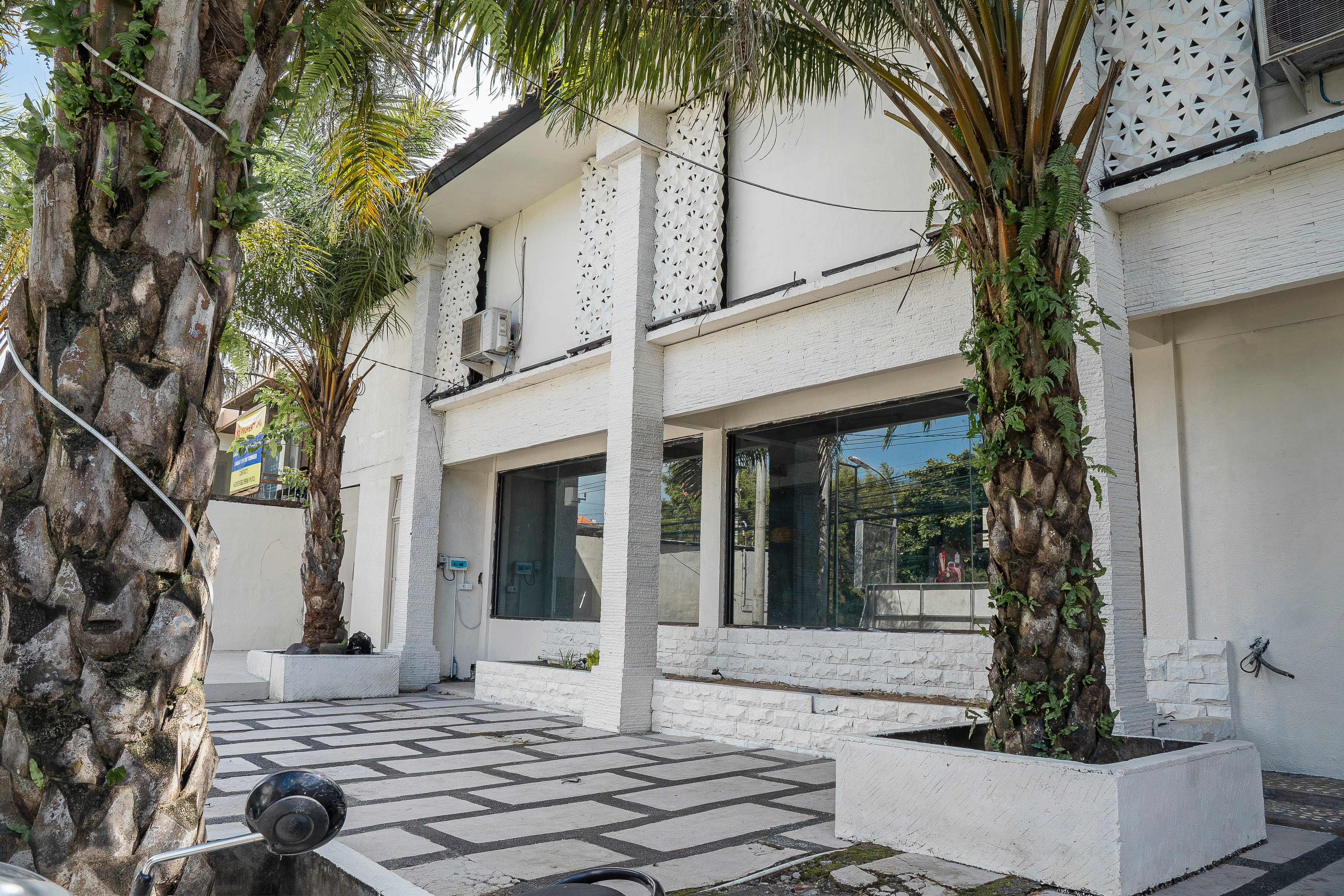 Exterior view with courtyard and palm trees