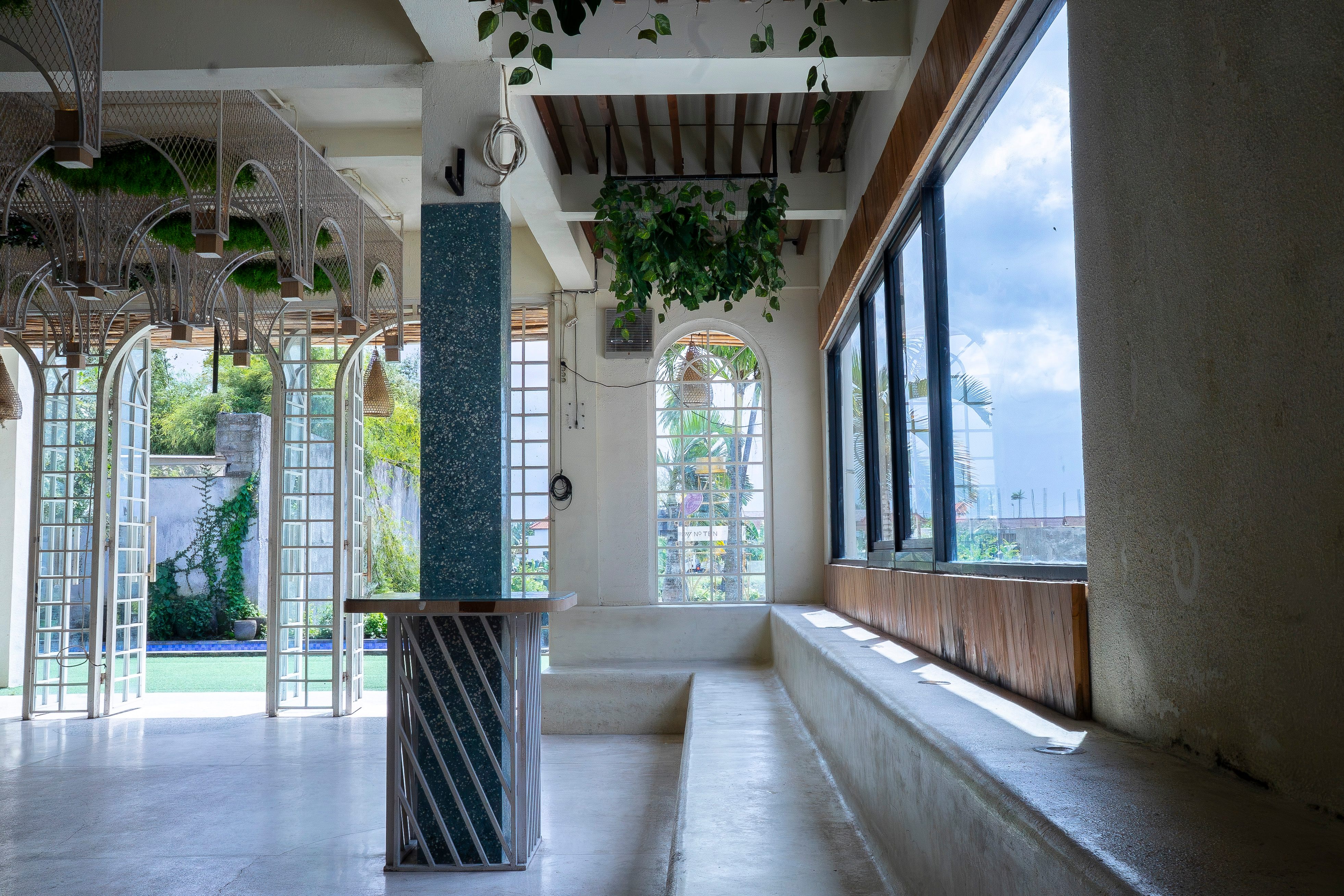 Ground floor interior showing arched windows and seating